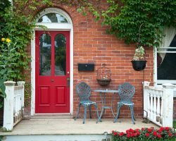 A front porch with a red door